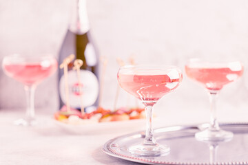 Champagne or wine in glasses on light background.