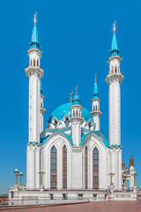 Beautiful white mosque with a blue roof against the blue sky.