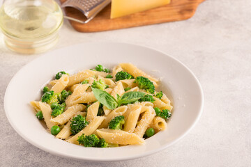 Pasta with green peas, broccoli and parmesan cheese.