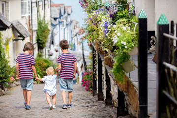 Fototapeta na wymiar Beautiful family, walking on the streets of Clovelly, nice old village in the heart of Devonshire