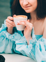 woman drinking coffee in the morning at restaurant. soft focus on eyes