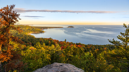 Autumn-colored dawn breaks over the Little Presque Isle and Lake Superior, viewed from Sugarloaf Mtn, Marquette, Michigan.