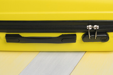 on a yellow gray background a suitcase for travel and a place for your inscription, close-up