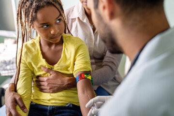 Pediatrician takes blood from a child patient. Healthcare antibody test coronavirus concept