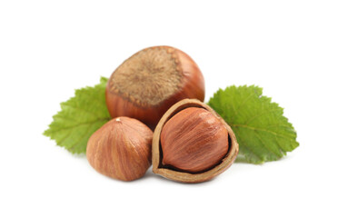 Tasty organic hazelnuts and leaves on white background