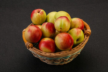 Sweet small nectarines in the basket