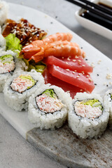 sushi on a plate served with shrimps and sashimi