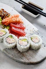 sushi on a plate served with shrimps and sashimi