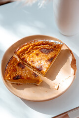 Pumpkin pie on a light brown rustic plate , halloween and thanksgiving.