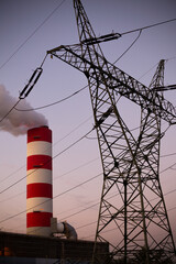 Close up for smoking chimney of the coal-fired power plant in Rybnik against the background of the evening sky. Photo taken during twilight under natural lighting conditions.