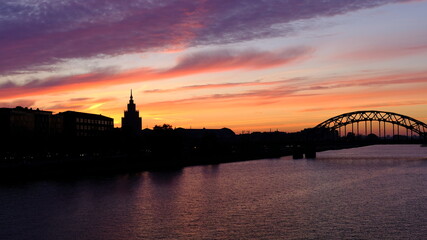 Fototapeta premium Railway bridge in Riga against the background of dawn in autumn.