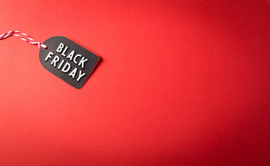 Top view of Black Friday sale tag on red background. Shopping concept boxing day and Black Friday composition.