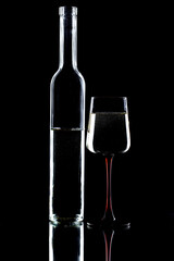 White wine in a glass, on a black background.