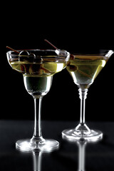White wine in a glass, on a black background.