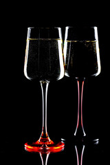 White wine in a glass, on a black background.