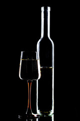 White wine in a glass, on a black background.