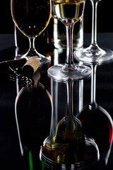 White wine in a glass, on a black background.