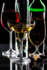 White wine in a glass, on a black background.