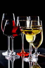 Glasses of wine on a black background.