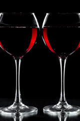 Red wine in a glass, on a black background.