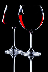 Red wine in a glass, on a black background.