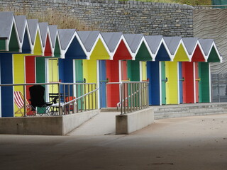brightly coloured beach huts