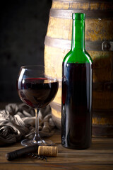 Wine in a glass, on an old background, with a bunch of grapes. Natural product.