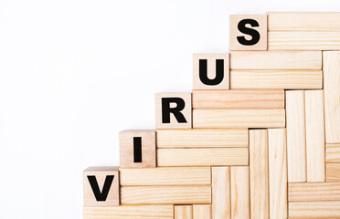 On a light background, wooden blocks and cubes with the text VIRUS