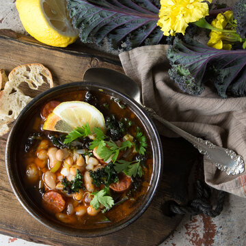 Bowl Of White Bean And Kale Soup On The Table