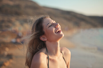 portrait of smiling woman at the beach