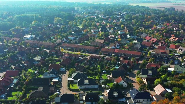 Aerial view of flight on the edge of a German suburb with streets and houses in a loose development from above