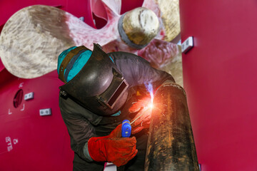 Welder Pipe welding metal steel in shipyard during pipe repair