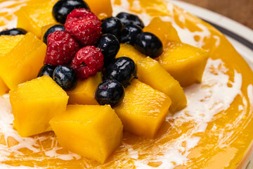 High angle view closeup of mango cheesecake. - Powered by Adobe