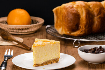 View of delicious homemade mango cheesecake in white ceramic dish.