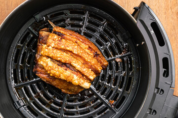 Crispy pork in black drawer of air fryers machine