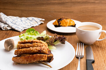 Piece of delicious homemade crispy pork in white ceramic dish.