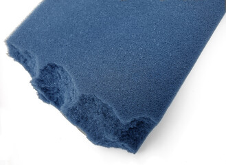 coarse pieces of sponge foam. thick blue material isolated on a white background. unused material.
