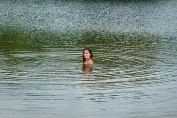 Young Indigenous Latin Woman is Swimming in San Salvador River, in Palomino, La Guajira, Colombia
