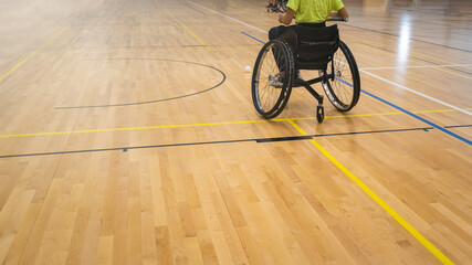 Athlete with disability playing wheelchair hockey with stick.