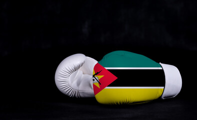 Boxing glove with Mozambique flag on black background