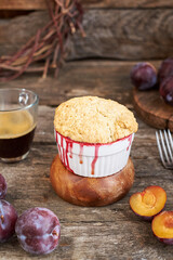 Plum cobbler on a wooden background.