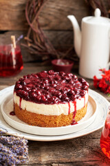 Cherry cake. Breton shortcrust pastry. Cheesecake. Cherry sauce. Side view. Wooden background.