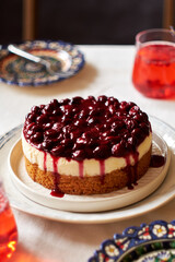Cherry cake. Breton shortcrust pastry. Cheesecake. Cherry sauce. Side view. Wooden background.