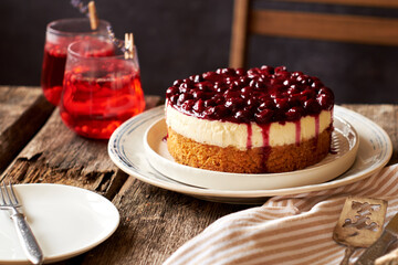 Cherry cake. Breton shortcrust pastry. Cheesecake. Cherry sauce. Side view. Wooden background.