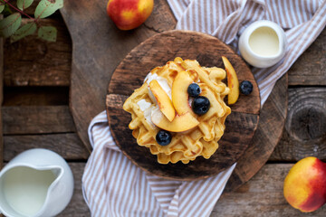 Belgian waffles blueberries. Top view, wooden background. Rustic.