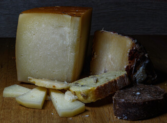two pieces, triangles, portions of cheese, idiazabal and from the Pyrenees, one vertical and the...