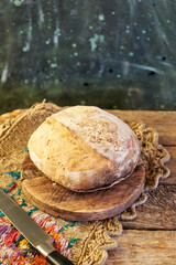 Homemade sourdough bread. Wooden background, side view.