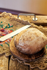 Homemade sourdough bread. Wooden background, side view.