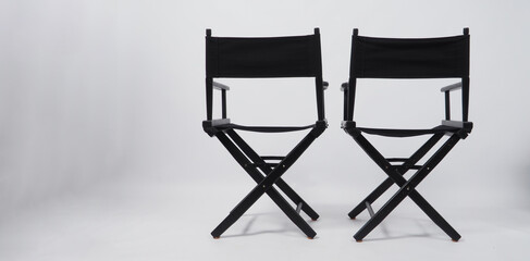 Back of black two director chair use in video production or movie and cinema industry on white...