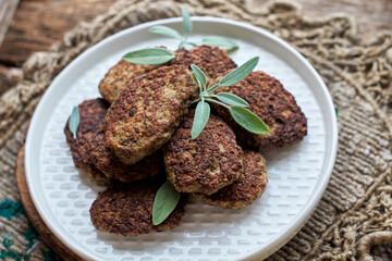 rissole on a wooden background decorated with sage.